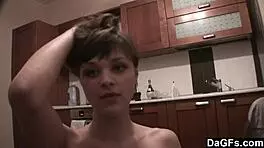 Dagfs - freckled-face babe plays with her dildo on kitchen counter, ripping clothes and exposing small 18+ tits and shaved pussy.