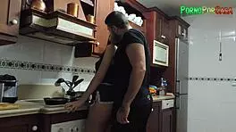 busty brunette seduces friend between the kitchen stoves