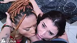 Two hot young girls, one black and one white, take big cock in their mouths