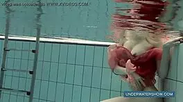 Katya okuneva bathes in pool wearing red dress