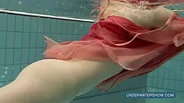 Katya okuneva bathes in pool wearing red dress