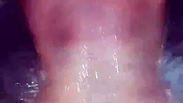 Sexy milf aggressively fucks her young boyfriend in the hot tub, showing off her big tits and ass.