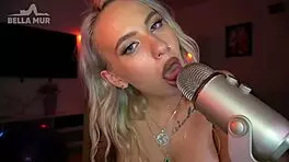 I moan as I lick the mic and spit on my tits, feeling so wet.