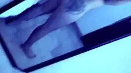 Ebony milf rides cock on webcam, showing naked body.