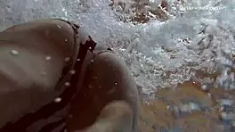 Lada Poleshuk bathes hot in pool, wet and underwater.