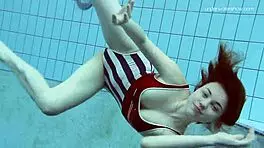 Lada Poleshuk bathes hot in pool, wet and underwater.