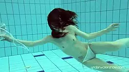 Roxalana swims in pool exposing tight pussy