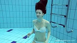 Roxalana swims in pool exposing tight pussy