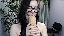 Sexy teen in glasses plays with huge dildo on her wet pussy