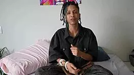 During the photoshoot, the singer with pigtails and tattoos gets intimate with the muscular assistant.