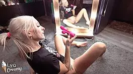 Blonde cutie fingers with toys at mirror