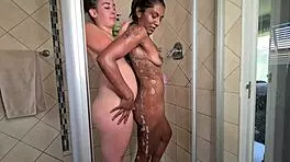 Watch these two mixed race lesbians in the shower, french kissing and playing with boobs and pussy!