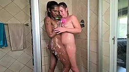 Watch these two mixed race lesbians in the shower, french kissing and playing with boobs and pussy!