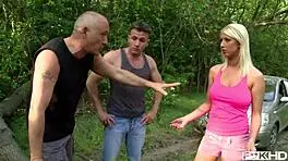 Busty blonde pamela passionately sucks two cocks in forest