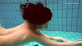 Petite 18+ brunette pornstar Alla swims naked in the hot pool, showing off her horny tits and ass while smoking