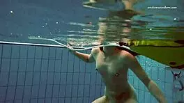 Petite 18+ brunette pornstar Alla swims naked in the hot pool, showing off her horny tits and ass while smoking