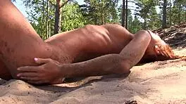 Naked redhead teen plays with water lily