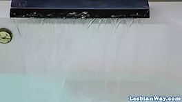 Les milf scissoring with teen in the bathtub