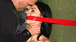 Submissive teen slave endures deepthroat blowjob and spanking before cumshot in bondage wood