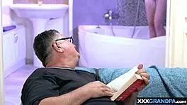 big boobed blondie suggestively cares for dirty old man's cock