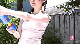 Peerless Beauty Frolics in Water Play Under Clear Sky, Feeling Adorable in Bikini