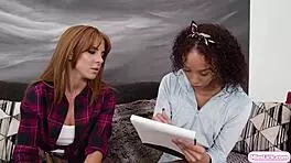 Redhead lesbian babe licks ebony girlfriend's pussy in scissoring session