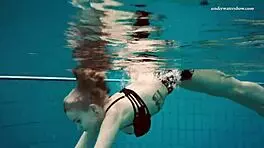 Dashka enjoys a beautiful swim in the pool, going from bikini to naked underwater.