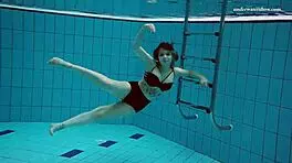 Dashka enjoys a beautiful swim in the pool, going from bikini to naked underwater.