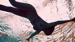 Dashka enjoys a beautiful swim in the pool, going from bikini to naked underwater.
