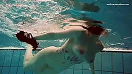 Dashka enjoys a beautiful swim in the pool, going from bikini to naked underwater.