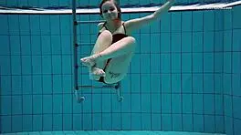 Dashka enjoys a beautiful swim in the pool, going from bikini to naked underwater.