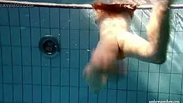 big tits brunette mia strips naked underwater in the pool, showing off her shaved body