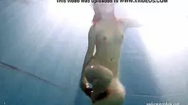 big tits brunette mia strips naked underwater in the pool, showing off her shaved body