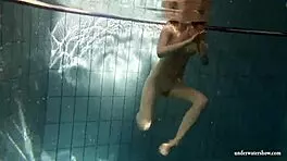 big tits brunette mia strips naked underwater in the pool, showing off her shaved body