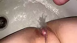 I’m working my wet pussy in the bathroom using a strong water jet.