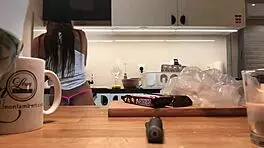 Young amateur wife does dishes while voyeur cam captures her in tight leggings and thong