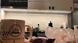 Young amateur wife does dishes while voyeur cam captures her in tight leggings and thong