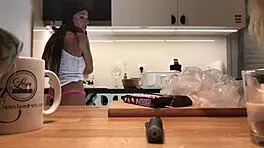 Young amateur wife does dishes while voyeur cam captures her in tight leggings and thong