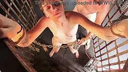 girl confined in cage with destructive machines