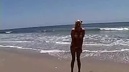 want to see this little blonde showing her natural tits and pussy at the beach?