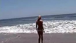 want to see this little blonde showing her natural tits and pussy at the beach?
