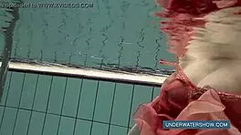 katya okuneva steps into the pool in a red dress, enjoying the outdoor beach scene underwater