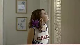 The petite cheerleader harley attempts an intriguing split pose.