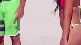 Young girl in micro bikini enjoys beach day with boyfriend's relatives