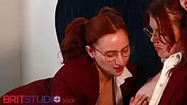 two redhead students in uniforms at a party