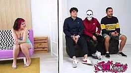 Young Mei, petite with short red hair, instructs three young dudes in a group lesson