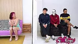 Young Mei, petite with short red hair, instructs three young dudes in a group lesson