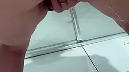 Teen bends over for juicy squirt in bathroom stall