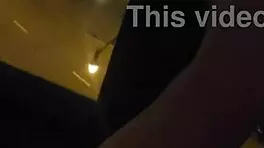 Milf masturbates in front of hotel window.