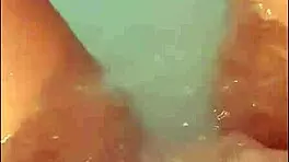 pretty woman masturbates in hot tub, ends with bright cumshot